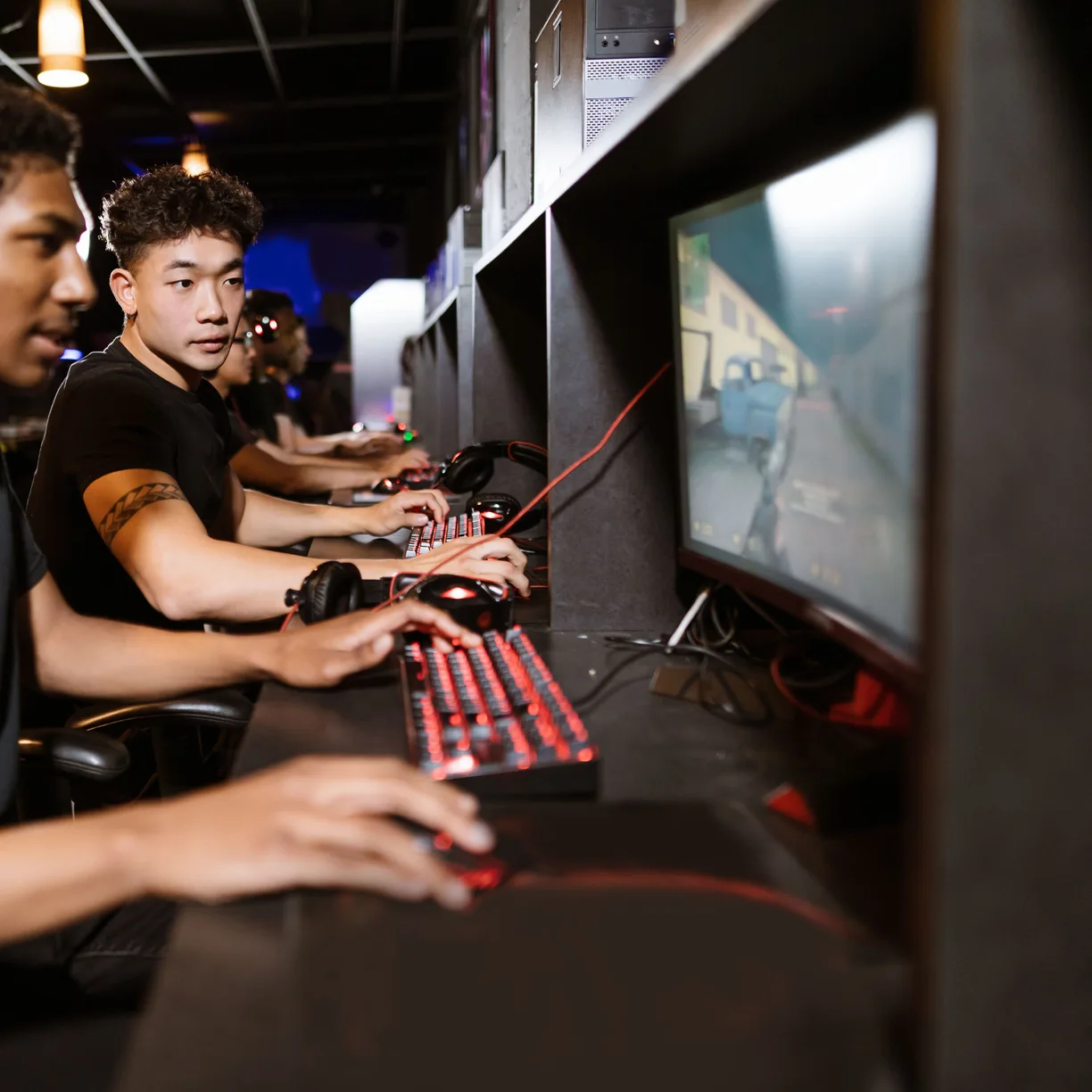 Esports competitors focused on their screens during a match