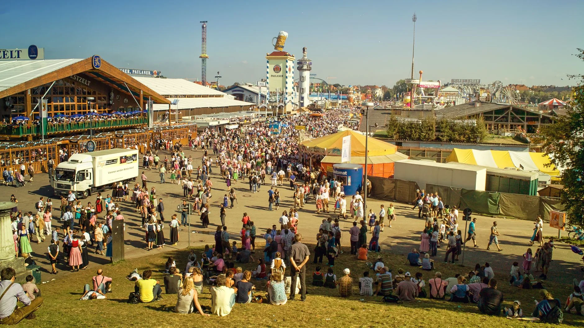 A packed crowd celebrating at Oktoberfest in traditional Bavarian dress