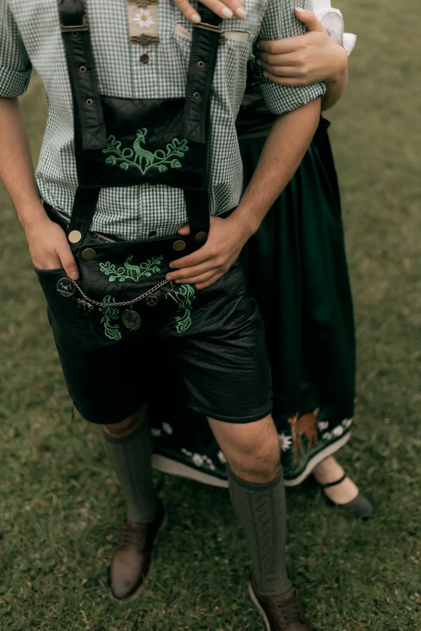 A couple in traditional Lederhosen and Dirndl at Oktoberfest