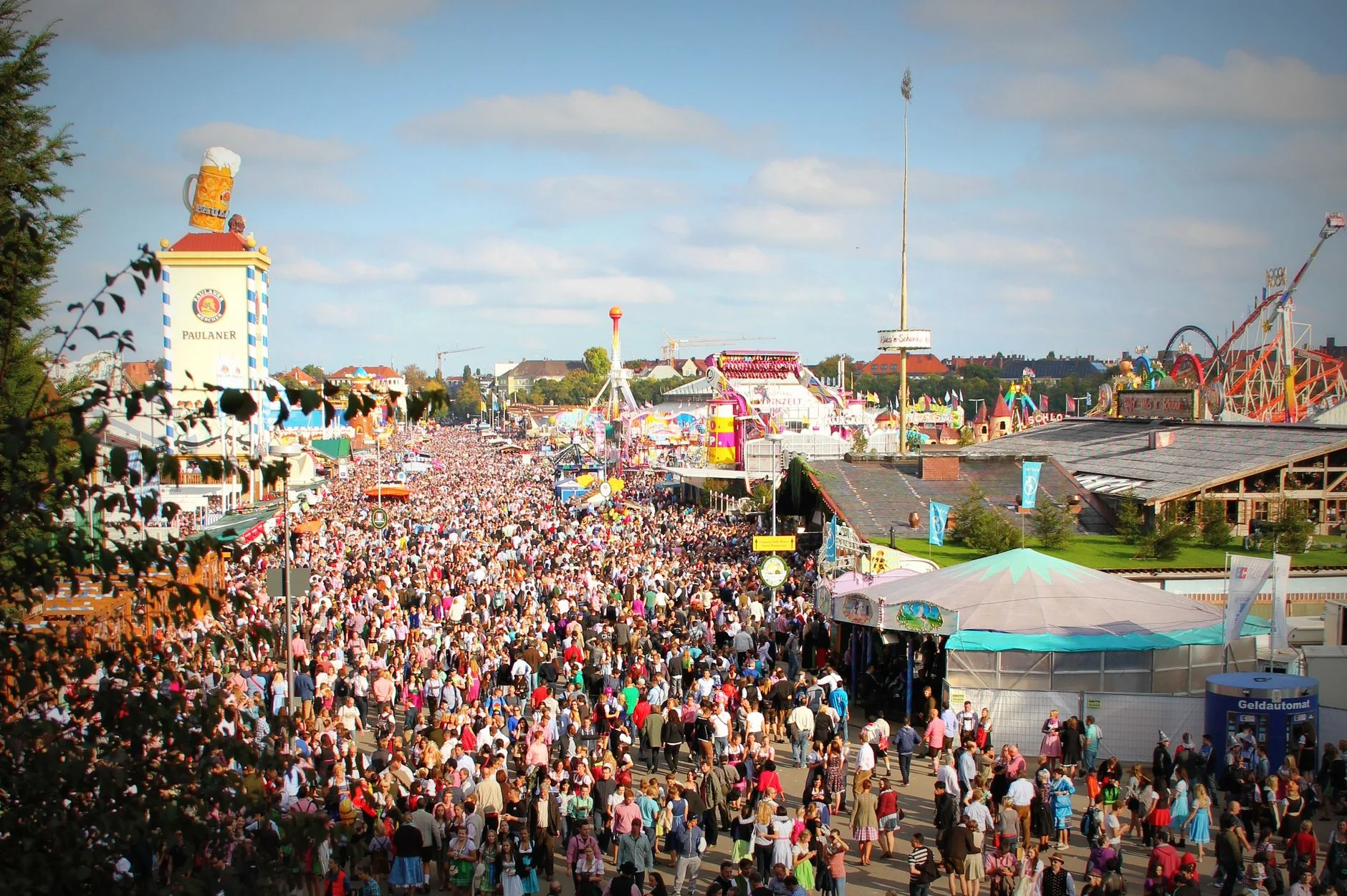 Aerial view of a large crowd gathered across the Oktoberfest fairground