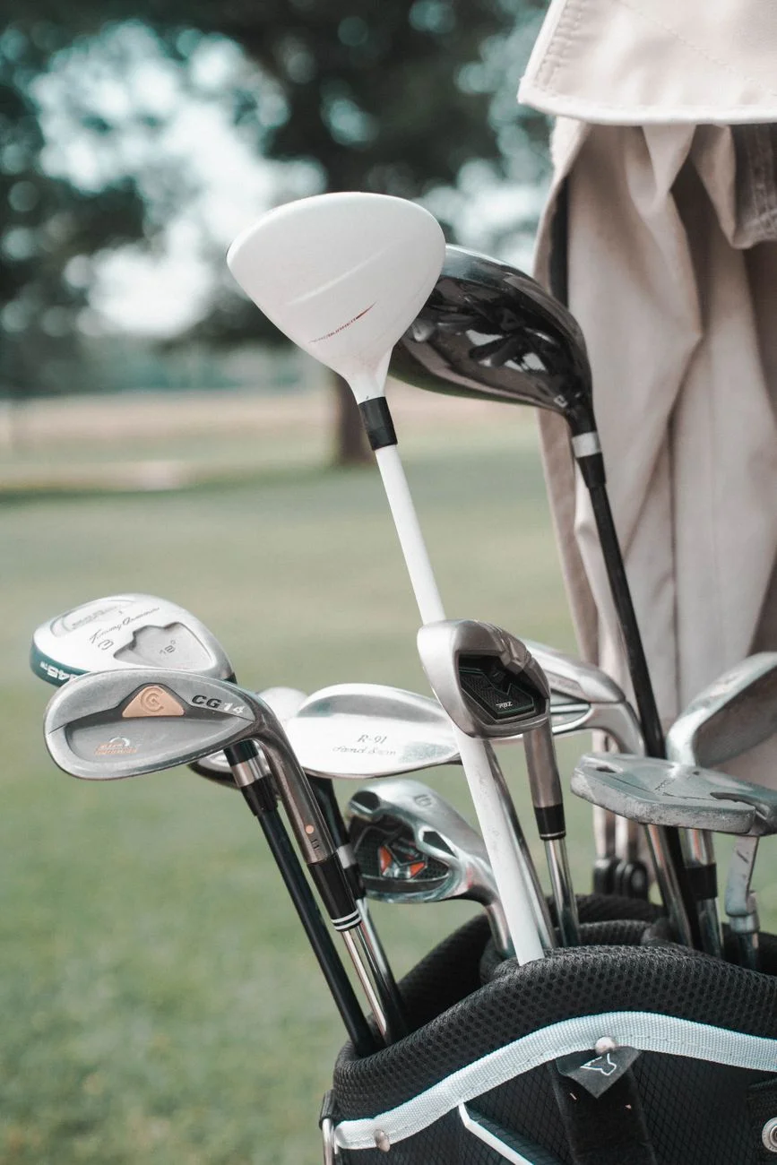 A set of golf clubs arranged in a bag